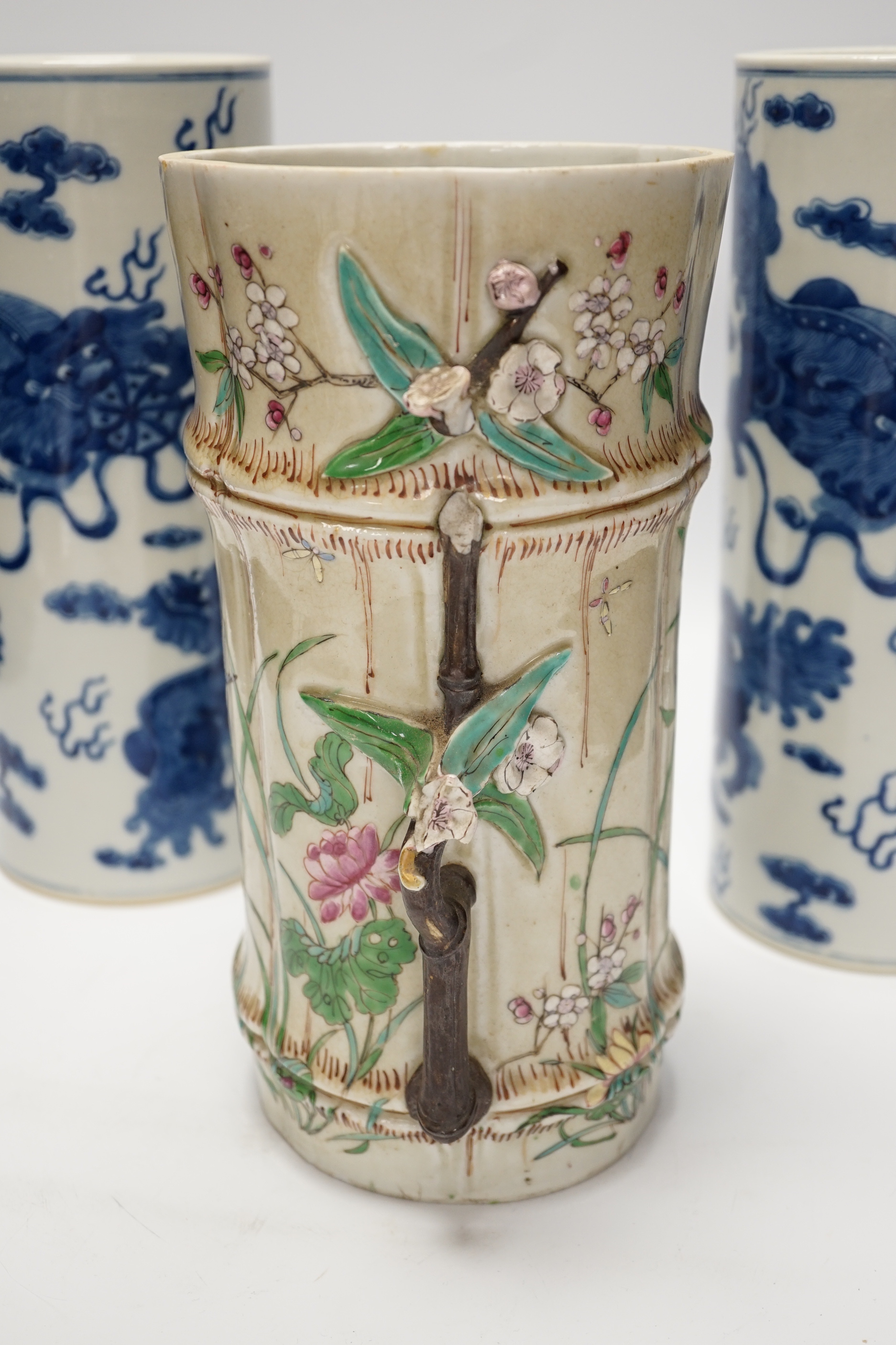 A pair of Chinese blue and white cylindrical hat stands, 29cm high and a Japanese porcelain vase modelled as bamboo